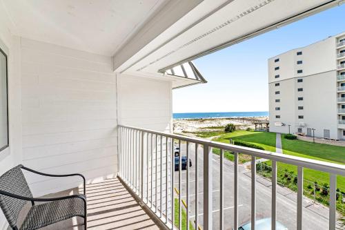 a balcony with a bench and a view of the beach at Plantation East #3312 in Gulf Highlands