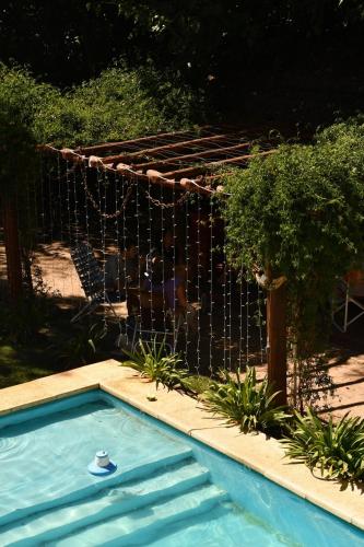 a swimming pool in front of a fence at Rincón de Rodríguez in General Rodríguez