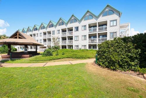 a large white building with a gazebo in a yard at Plantation West #1365 in Fort Morgan