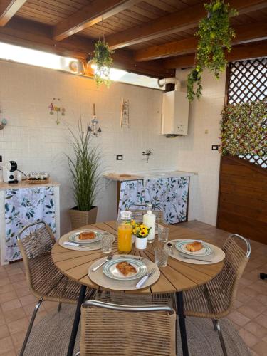 a wooden table with plates of food on it at SvEly House B&B in Campomarino