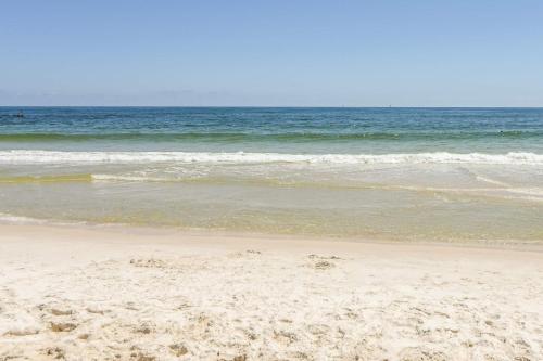 a sandy beach with the ocean in the background at Contemporary beachside escape with gym & pools in Fort Morgan