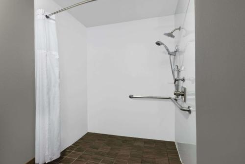 a bathroom with a shower with a shower curtain at Hotel 1550 - SFO Airport FREE Shuttle in San Bruno