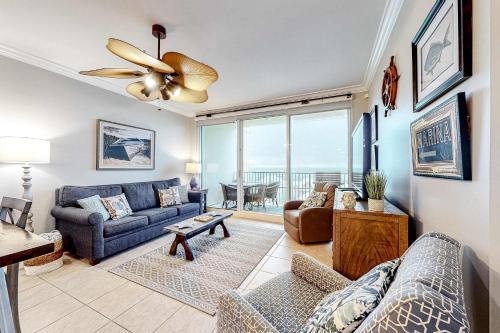 a living room with a couch and a ceiling fan at The Indies #503 in Fort Morgan