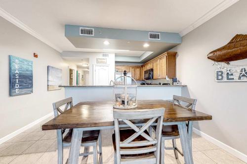 a kitchen with a wooden table and chairs at The Indies #503 in Fort Morgan
