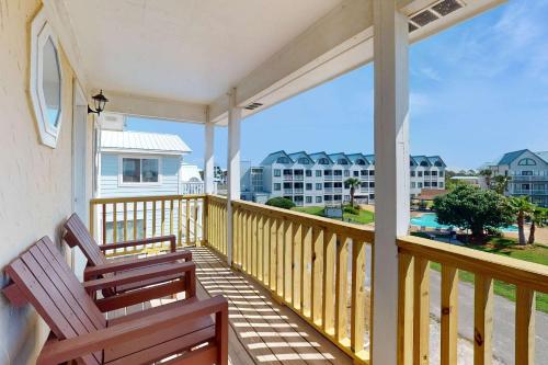 a balcony with two chairs and a view of the ocean at Gulf view duplex with multi-level balcony hot tub in Fort Morgan