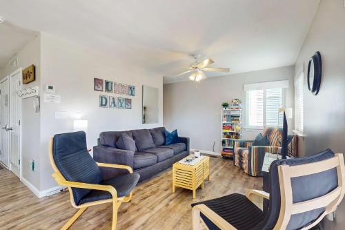a living room with a blue couch and chairs at Gulf view duplex with multi-level balcony hot tub in Fort Morgan