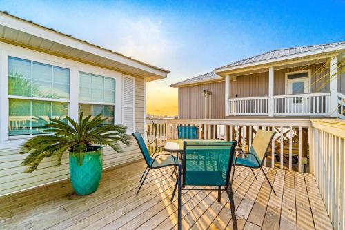 a deck with chairs and a table and a house at Blue Marlin in Gulf Shores