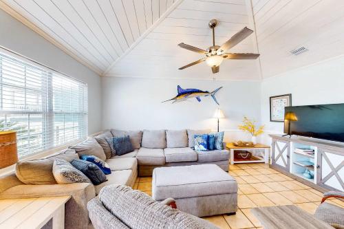 a living room with a couch and a ceiling fan at Blue Marlin in Gulf Shores
