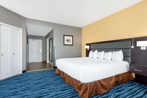 a hotel room with a large bed and a doorway at Hotel 1550 - SFO Airport FREE Shuttle in San Bruno