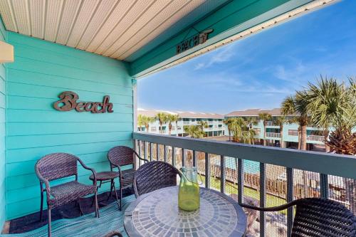 a patio with a table and chairs on a balcony at Beautiful condo with shared pools full kitchen private washer dryer in Gulf Shores