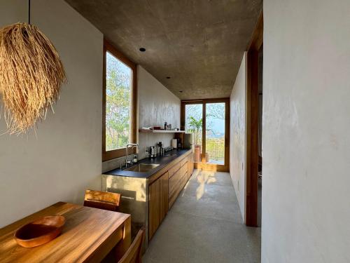 a kitchen with a sink and a wooden table at El Guayacan in Zipolite