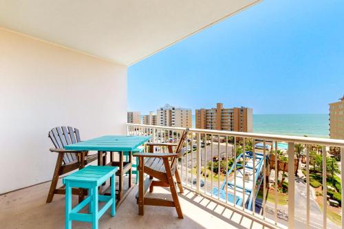 a balcony with a table and chairs and the ocean at Crystal Tower 705 in Gulf Shores