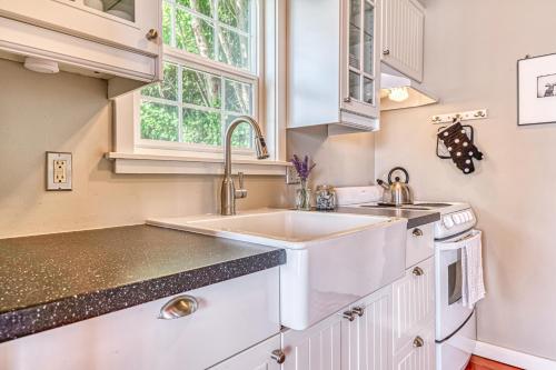 a white kitchen with a sink and a window at 2BR Beachfront Cottage w/ Grill & Expansive Deck in Point Roberts