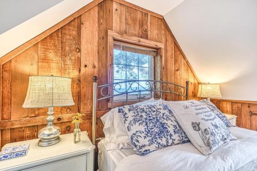 a bedroom with a bed with a wooden wall at 2BR Beachfront Cottage w/ Grill & Expansive Deck in Point Roberts