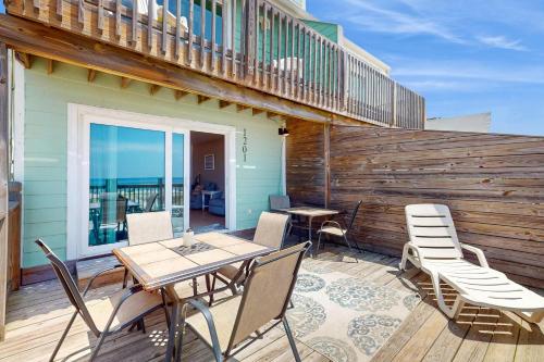 a patio with a table and chairs on a deck at Sweet Alabama in Gulf Shores