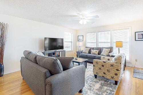 a living room with a couch and a tv at Sea Oats E106 in Gulf Shores
