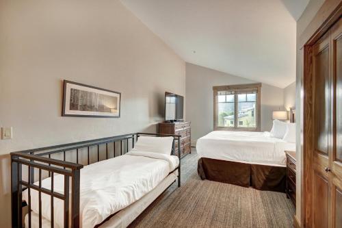 a bedroom with two beds and a window at Mountain Thunder Lodge, A Vail Resorts Property in Breckenridge
