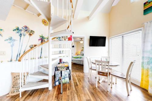 a room with a spiral staircase and a dining room at Plantation West #1354 in Gulf Shores