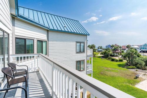 a balcony of a house with two chairs at Plantation West #1354 in Gulf Shores
