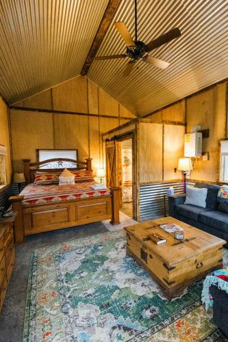 a bedroom with a bed and a couch and a ceiling fan at The Trail Head in South Fork
