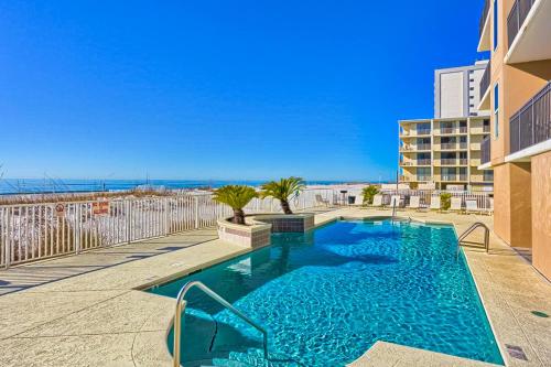 a swimming pool with a view of the ocean at Beachfront condo with shared pool outdoor shower and beach access in Gulf Shores