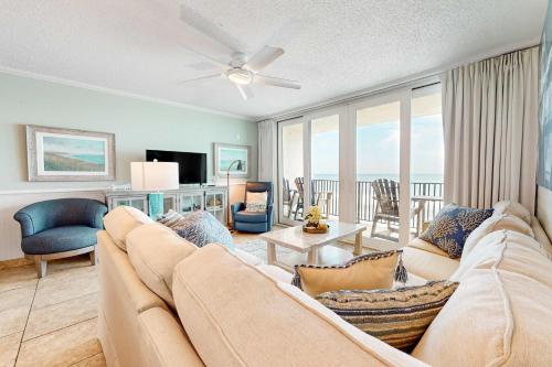 a living room with a couch and a television at Gulf-front condo with breathtaking views pool in Orange Beach
