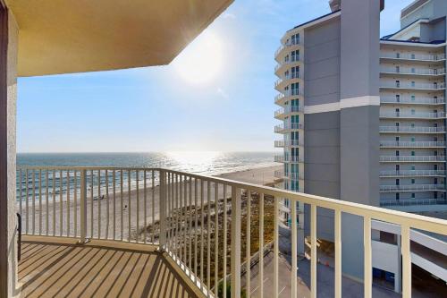 a balcony with a view of the beach and a building at The Whaler 7B in Gulf Shores