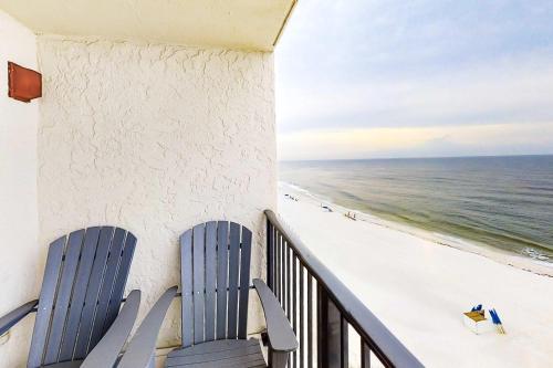 two chairs on a balcony looking out at the beach at Beachfront Condo with Gulf View Balcony WiFi AC & Shared Pools in Orange Beach