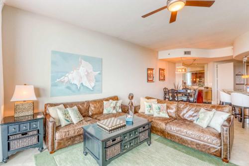a living room with a couch and a table at Bella Luna 1203 in Orange Beach