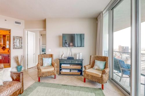 a living room with a couch and chairs and a tv at Bella Luna 1203 in Orange Beach