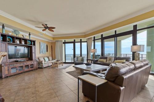 a living room with a couch and a tv at Phoenix West 2601 in Orange Beach