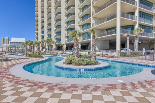 a swimming pool in front of a large building at Phoenix West 2601 in Orange Beach