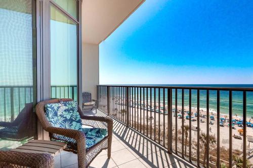 a balcony with a chair and a view of the beach at Phoenix West 502 in Orange Beach
