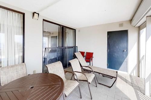 a dining room with a wooden table and chairs at Pelican Pointe 302 in Orange Beach