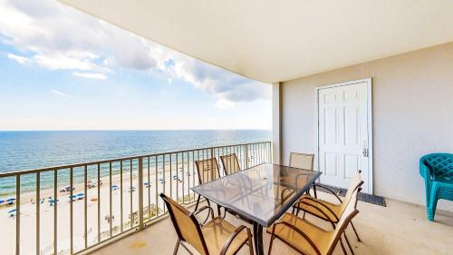 a balcony with a table and chairs and the ocean at Regency Isle 805 in Orange Beach