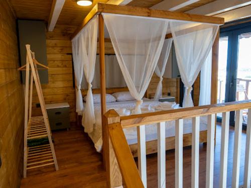 a bedroom with a canopy bed in a cabin at Villa Maris in Demre