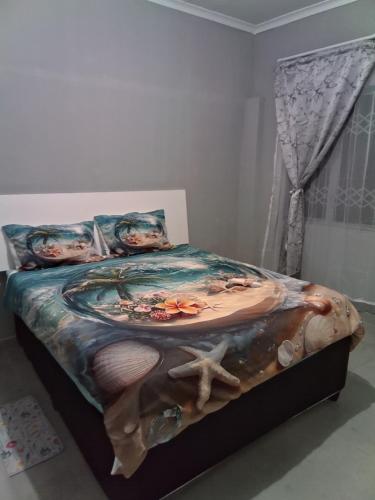 a bedroom with a bed with a painting on it at Cozy suburban guest house - Durban in Verulam