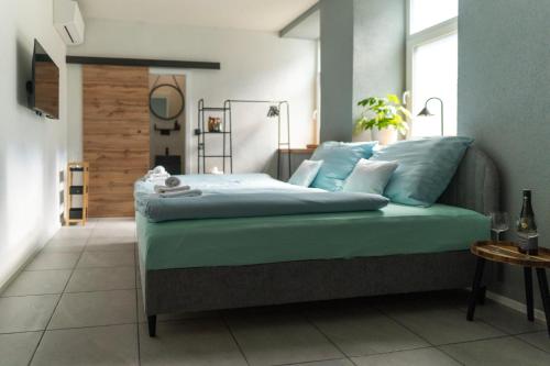 a bedroom with a bed with blue sheets and pillows at Rezidence 14 Nový Bor in Nový Bor