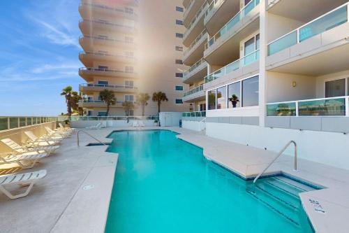 a swimming pool on the side of a building at Silver Beach 601 in Orange Beach