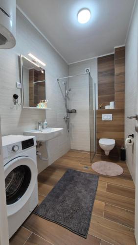 a bathroom with a washing machine and a sink at Trebevic Skyline Apartman in Dovlići