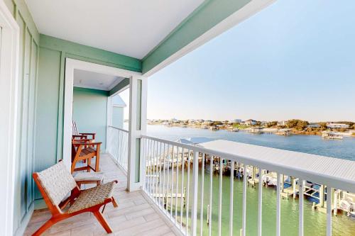 a balcony with a chair and a view of the water at Jubilee Landing 302 in Orange Beach