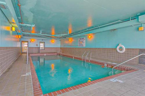 a swimming pool with blue water in a building at Phoenix East 702 in Orange Beach