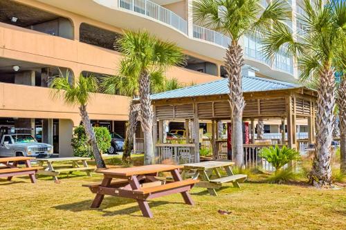 a group of picnic tables in front of a building at Regency Isle 611 in Orange Beach