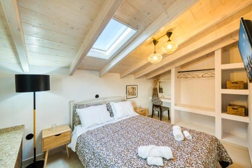 a bedroom with a bed and a skylight at Kalamoti Suites in Kalamoti