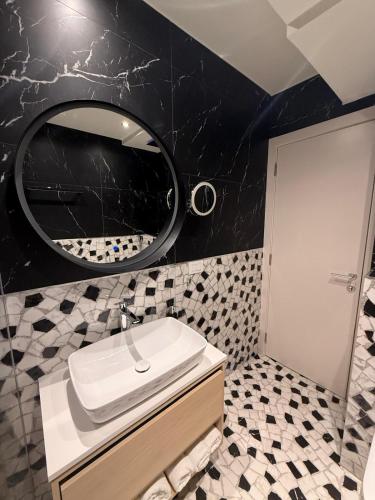 a bathroom with a sink and a mirror at Dorćol Center Suites in Belgrade