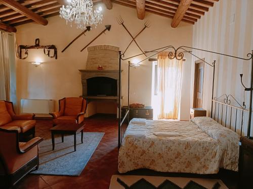 a bedroom with a bed and a chandelier at villa colticciola Agriturismo Marche in Cagli