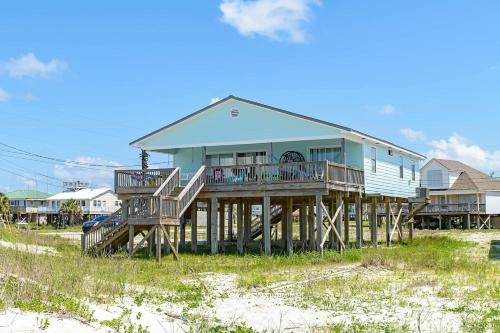 a house on wooden posts on the beach at Little Grand Hotel in Dauphin Island