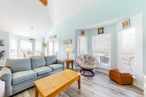 a living room with a couch and a table at Sunset Beach in Dauphin Island