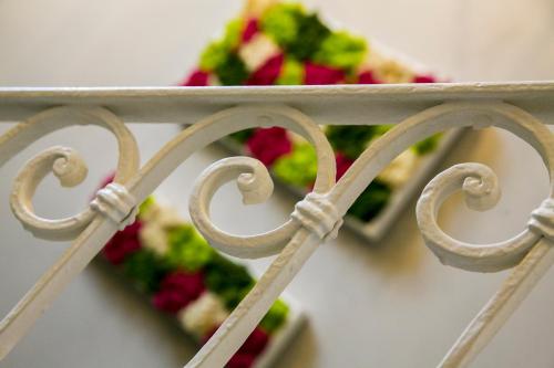 a close up of a metal fence with flowers at Navigliotel 19 - Rooms & Suites in Milan