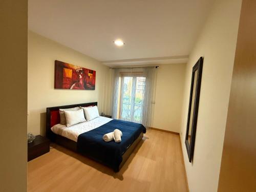 a bedroom with a bed with a stuffed animal on it at Sol Poente Praia Apartment in Apúlia